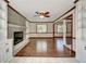 Living room featuring a brick fireplace, built-in shelving, and hardwood floors at 606 Evergreen Dr, Woodstock, GA 30188