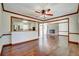 Spacious living room with hardwood floors, white brick fireplace, and open floorplan at 606 Evergreen Dr, Woodstock, GA 30188