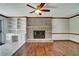 Living room featuring a brick fireplace, built-in shelving and hardwood floors at 606 Evergreen Dr, Woodstock, GA 30188