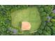Aerial view of a baseball field with lush trees and walking path at 161 Highgrove Dr, Suwanee, GA 30024