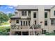 Back of house featuring a deck with patio furniture and landscaped yard at 161 Highgrove Dr, Suwanee, GA 30024