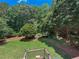 Lush backyard with mature trees and landscaping, offering a private and tranquil outdoor space at 161 Highgrove Dr, Suwanee, GA 30024