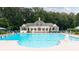 Resort-style community pool with clubhouse and plenty of lounge chairs at 161 Highgrove Dr, Suwanee, GA 30024