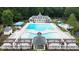 Aerial view of a large community pool with ample seating and sunshades at 161 Highgrove Dr, Suwanee, GA 30024