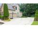 Side of home with a spacious driveway, two-car garage, and basketball hoop at 161 Highgrove Dr, Suwanee, GA 30024