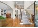 Grand foyer with hardwood floors, staircase, and elegant architectural details at 161 Highgrove Dr, Suwanee, GA 30024