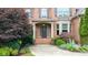 Inviting front entrance with brick steps, decorative plants, and a covered porch at 161 Highgrove Dr, Suwanee, GA 30024
