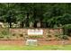 Stone community welcome sign with lush landscaping at 161 Highgrove Dr, Suwanee, GA 30024
