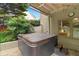 Outdoor hot tub providing a private and relaxing retreat, surrounded by lush greenery and privacy at 161 Highgrove Dr, Suwanee, GA 30024