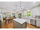 Open kitchen featuring stainless appliances, light countertops, a central island and seamless access to the dining and living areas at 161 Highgrove Dr, Suwanee, GA 30024
