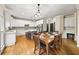 Bright kitchen with white cabinets, stainless steel appliances, a center island and an adjacent dining area at 161 Highgrove Dr, Suwanee, GA 30024