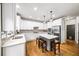 Bright kitchen features stainless appliances, quartz countertops, a central island and bar stool seating at 161 Highgrove Dr, Suwanee, GA 30024