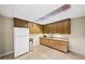 Cozy kitchenette with wooden cabinetry, granite countertops, and essential appliances at 161 Highgrove Dr, Suwanee, GA 30024