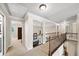 Open hallway upstairs with neutral paint, carpeted floors, and decorative iron railing at 161 Highgrove Dr, Suwanee, GA 30024