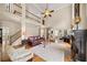 Bright living room featuring vaulted ceilings, fireplace, hardwood floors, and a second-floor balcony at 161 Highgrove Dr, Suwanee, GA 30024