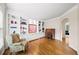 Bright living room with custom built-ins, hardwood floors, and a cozy reading nook with natural light at 161 Highgrove Dr, Suwanee, GA 30024