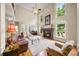 Inviting living room with a fireplace, tall windows, and comfortable seating at 161 Highgrove Dr, Suwanee, GA 30024