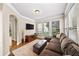 Comfortable living room with plush sectional sofa, large windows, and a media console with TV at 161 Highgrove Dr, Suwanee, GA 30024