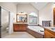 Elegant bathroom with soaking tub, separate shower, and granite counters at 161 Highgrove Dr, Suwanee, GA 30024