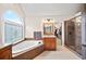 Elegant bathroom with soaking tub, separate shower, and granite counters at 161 Highgrove Dr, Suwanee, GA 30024