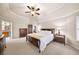 Spacious bedroom with a ceiling fan, carpet, and access to main bath at 161 Highgrove Dr, Suwanee, GA 30024