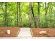 Scenic nature trail entrance with a 'Nature Trail' sign surrounded by lush greenery and peaceful woodland at 161 Highgrove Dr, Suwanee, GA 30024
