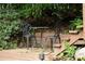 Quaint patio area with decorative wrought iron table and chairs, creating an inviting outdoor retreat at 161 Highgrove Dr, Suwanee, GA 30024