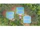 Aerial shot of three tennis courts surrounded by lush trees at 161 Highgrove Dr, Suwanee, GA 30024