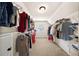 Spacious walk-in closet with carpet, ample shelving, and natural light at 161 Highgrove Dr, Suwanee, GA 30024