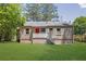 Charming home exterior showcasing fresh lawn and a red door at 2115 Pinehurst Dr, East Point, GA 30344