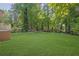 Lush backyard features manicured lawn and mature trees at 2115 Pinehurst Dr, East Point, GA 30344