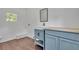 Bathroom boasts stylish vanity, vessel sink, and wood-look flooring for a modern touch at 2115 Pinehurst Dr, East Point, GA 30344