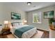 Cozy bedroom features a plush bed, bedside tables with lamps, and natural light at 2115 Pinehurst Dr, East Point, GA 30344