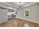 Bright dining area adjacent to the kitchen, with a modern chandelier and ample space at 2115 Pinehurst Dr, East Point, GA 30344