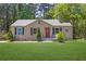 Charming single-story home with a well-maintained lawn and a cozy front porch at 2115 Pinehurst Dr, East Point, GA 30344
