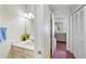 Well-lit bathroom features a cream vanity, framed mirror, and view to the living room at 2565 Holcomb Springs Dr, Alpharetta, GA 30022
