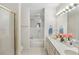 A well-lit bathroom features a double vanity, step-up tub, and shower with a gold trimmed sliding door at 2565 Holcomb Springs Dr, Alpharetta, GA 30022