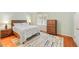 Bedroom with neutral walls, a comfortable bed, matching dressers, and natural light from the window at 2565 Holcomb Springs Dr, Alpharetta, GA 30022