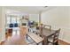 Open dining room adjacent to living room with hardwood floors and seating for six at 2565 Holcomb Springs Dr, Alpharetta, GA 30022