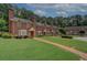 Charming townhomes featuring brick exteriors, lush green lawns, and inviting pathways at 2565 Holcomb Springs Dr, Alpharetta, GA 30022