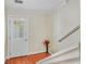 Hallway view featuring a hardwood floor, a stairway, and a door with glass panels at 2565 Holcomb Springs Dr, Alpharetta, GA 30022