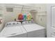 Functional laundry room with a washer, dryer, and wire shelving for storage at 2565 Holcomb Springs Dr, Alpharetta, GA 30022