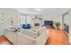 Bright living room with hardwood floors, fireplace, bay window, and open to dining area at 2565 Holcomb Springs Dr, Alpharetta, GA 30022