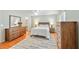 This is a main bedroom with wood furniture, modern decor, and access to the en suite bathroom at 2565 Holcomb Springs Dr, Alpharetta, GA 30022