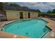 Community pool surrounded by lounging chairs and picnic tables for residents' enjoyment at 2565 Holcomb Springs Dr, Alpharetta, GA 30022
