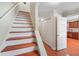 Stairway leading to the upper level, adjacent to the kitchen and a closet at 2565 Holcomb Springs Dr, Alpharetta, GA 30022