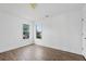 Bedroom with wood floors and a double window view of a lush green lawn and trees, plus neutral paint at 327 Awendaw Cir, Ellenwood, GA 30294