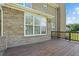 Spacious wood deck off the back of a brick home, featuring wooden railings and large windows, ideal for outdoor entertaining at 327 Awendaw Cir, Ellenwood, GA 30294