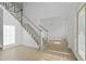 Bright foyer with wood-look floors, staircase, and a glimpse into the formal living area at 327 Awendaw Cir, Ellenwood, GA 30294