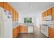 Bright kitchen with wooden cabinets, white countertops, stainless steel appliances and wood-look floors at 327 Awendaw Cir, Ellenwood, GA 30294